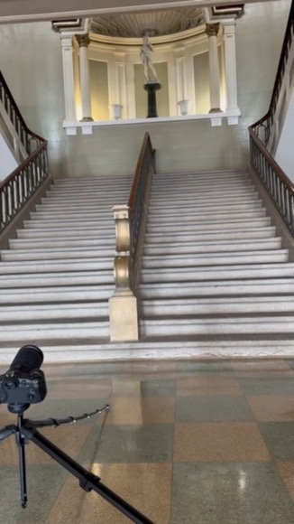 The grand marble staircase inside East High School, rising toward the arched upper landing
