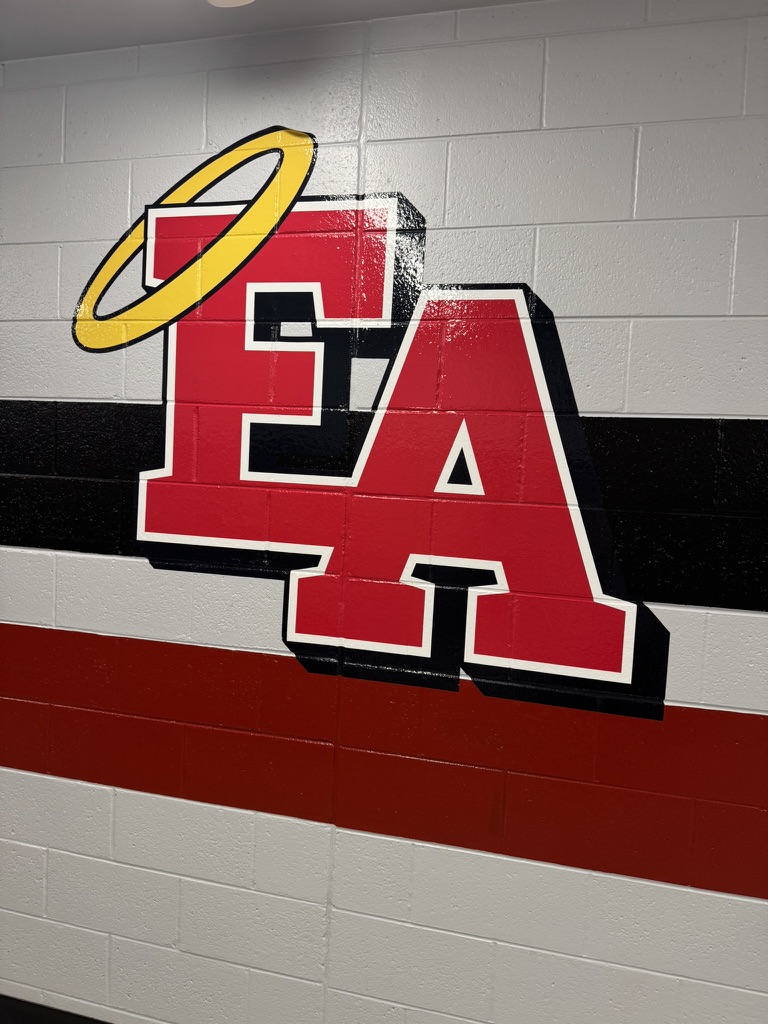 The red EA Angels emblem with its halo painted on a corridor wall at East High School