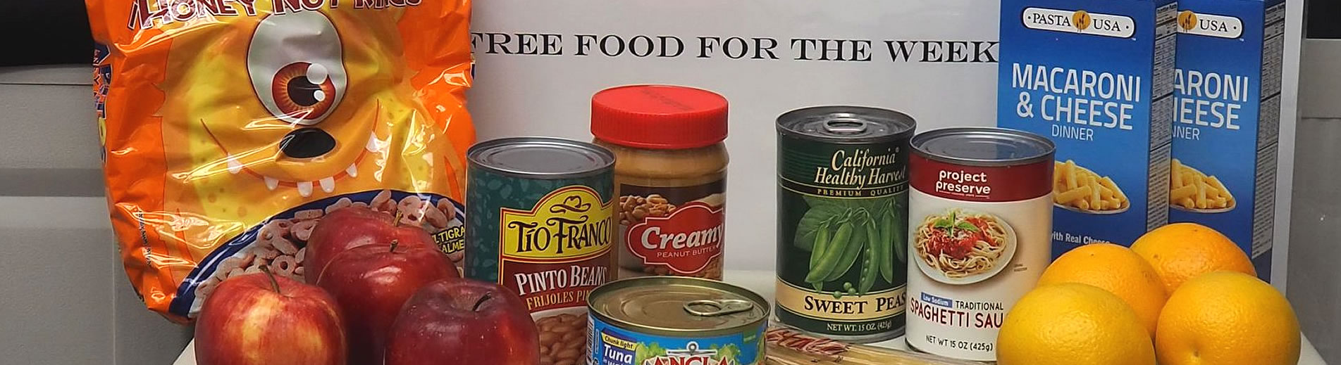 Volunteers assembling East Angel Pantry food packs for students and families