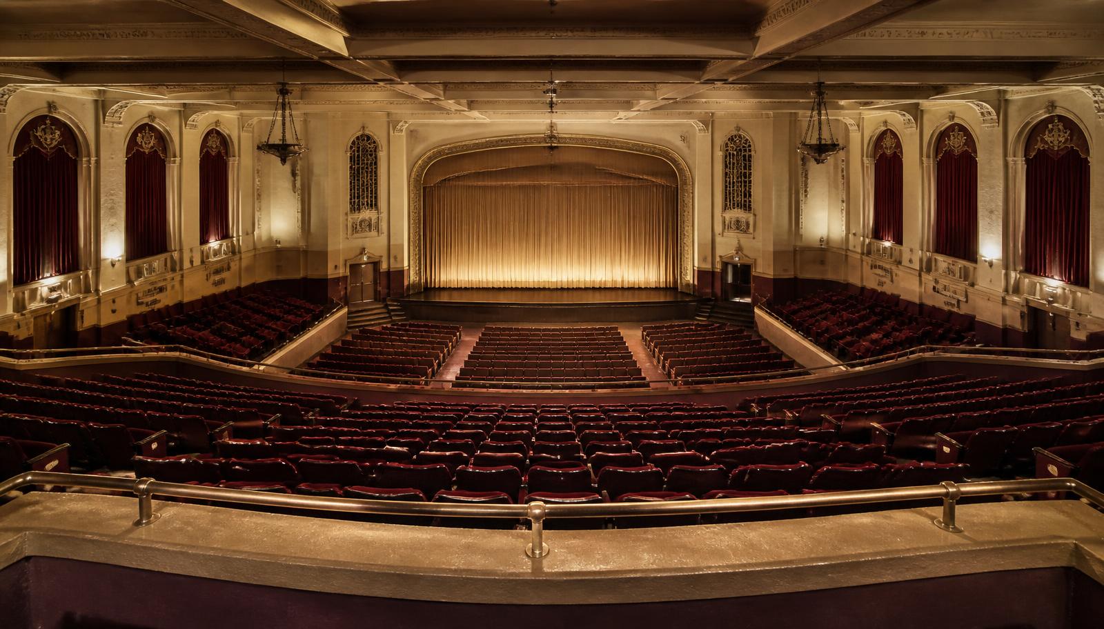 Wide view of a historic school auditorium from the balcony
