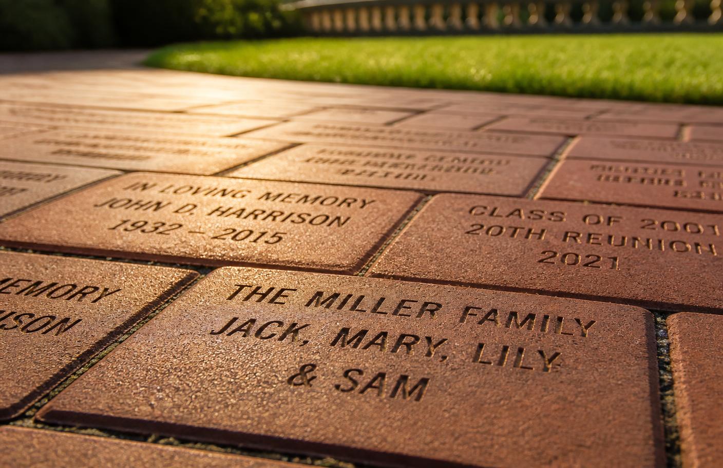 Engraved commemorative brick pavers in a walkway